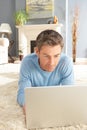 Man Using Laptop Relaxing Laying On Rug At Home Royalty Free Stock Photo