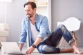 Man using laptop and sitting on floor Royalty Free Stock Photo