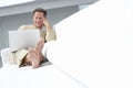 Man using laptop on sofa in living room Royalty Free Stock Photo