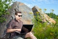 Man using a laptop in summer day Royalty Free Stock Photo