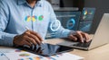 Man working on laptop and tablet with data analytics overview display Royalty Free Stock Photo