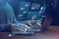 Man using laptop to access digital data and analytics on a screen in a workspace setting Royalty Free Stock Photo