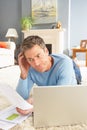 Man Using Laptop To Manage Bills Laying On Rug Royalty Free Stock Photo