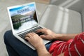 Man using laptop to plan trip. Travel agency website