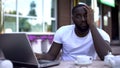 Man using laptop, upset with unemployment, labor-market crisis, job search