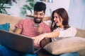 Man using laptop and woman holding credit card. Royalty Free Stock Photo