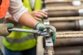 Man using a large wrench fixing machine in factory. Plant site and hand man use large wrench. Royalty Free Stock Photo