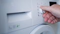 Man Using a Laundry Machine Modern Appliance for Washing and Cleaning Dirty Clothes