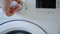 Man Using a Laundry Machine Modern Appliance for Washing and Cleaning Dirty Clothes