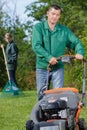 man using lawnmower and girl wiping Royalty Free Stock Photo