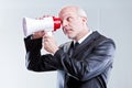 Man using a megaphone with eyes instead of mouth