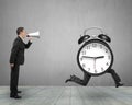 Man using megaphone shouting running clock with human legs