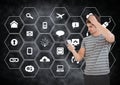 Man using mobile phone against application icons on black background Royalty Free Stock Photo