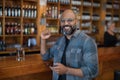 Man using mobile phone at counter in bar Royalty Free Stock Photo