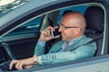 Man using mobile phone while driving car to work. Risky, reckless driver bad habits Royalty Free Stock Photo