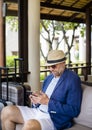 Man using mobile phone at hotel lobby Royalty Free Stock Photo