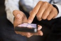 Man using a mobile phone on sofa, indoor