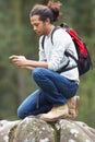 Man Using Mobile Phone Whilst Hiking In Countryside