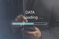 Man using mobile smartphone for download application and waiting to loading from online server, Upload, download, internet, Royalty Free Stock Photo