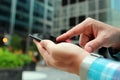 Man using a modern mobile phone outside