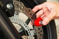 Man Using Motorcycle Disc Brake Lock to Secure His Motorcycle form Thief Royalty Free Stock Photo