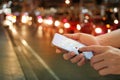 Man using navigation app on the smartphone on street at night