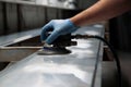 Man using orbital sander on metal