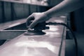 Man using orbital sander to prepare a metal panel. Royalty Free Stock Photo