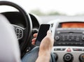 Man using phone while driving the car Royalty Free Stock Photo