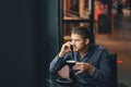 Man using phone inside a restaurant