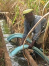 Man using pipes canal and pipes to irrigate sugarcane