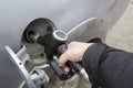 A man using a pistol refuels a car NP gas station