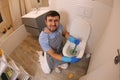 Man using plunger in the bathroom Royalty Free Stock Photo