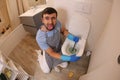 Man using plunger in the bathroom Royalty Free Stock Photo