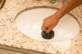 Man Using Plunger to unstop his sink Royalty Free Stock Photo