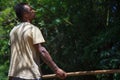 Man using pole to sail the bamboo raft in the river. One of career for tourism at Chiang Mai province in Thailand.Jungle and