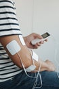 a man using a portable electrotherapy device Royalty Free Stock Photo