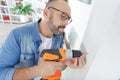 man using power drill on wall at home Royalty Free Stock Photo