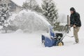 Man using a powerful snow blower Royalty Free Stock Photo
