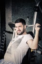 Man using pull down machine in gymnasium.Handsome muscular man exercising on pull down machine.