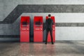 Man using red ATM machine Royalty Free Stock Photo