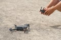 Man using remote control to operating drone assign blurred land. Royalty Free Stock Photo