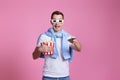 man using remote controller watching movie with big bucket of popcorns Royalty Free Stock Photo