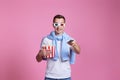 man using remote and holding a big bucket of popcorns Royalty Free Stock Photo