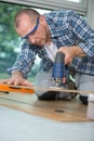 Man using saw to cut wood Royalty Free Stock Photo