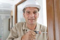 Man using screwdriver to adjust door hinge Royalty Free Stock Photo