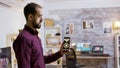 Man using a smart lights application to turn on the light bulbs in the house Royalty Free Stock Photo