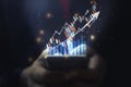 A man using smart phone analyzing graph for data management to make report. Royalty Free Stock Photo