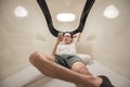 man using smart phone in capsule hotel