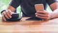 A man using smart phone and holding coffee cup Royalty Free Stock Photo